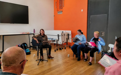 Debs leads the inaugural music group on guitar